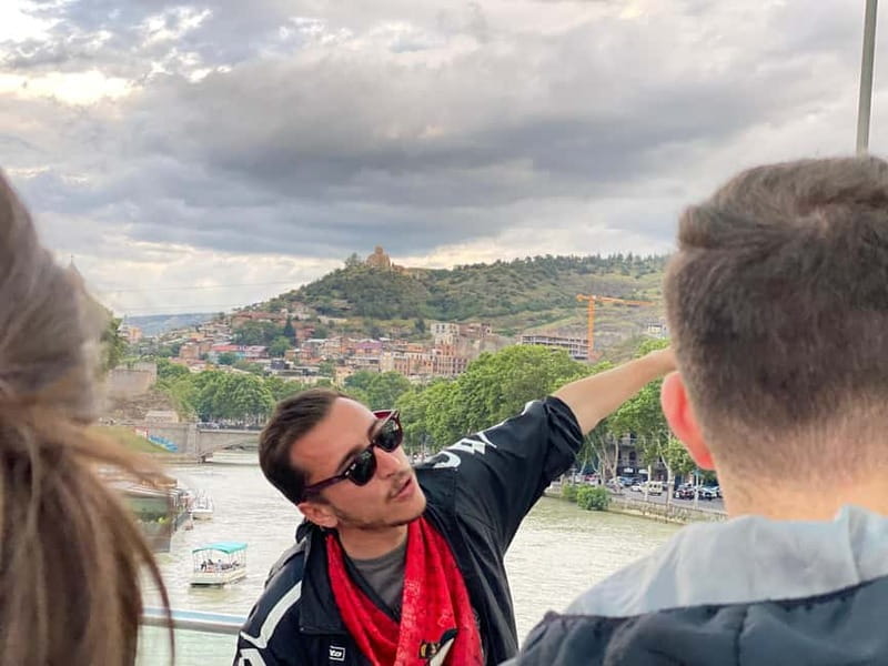 Tbilisi: Evening Walking Tour with Wine & Boat Ride Options - Bridge of Peace at night: the LED glow over the Mtkvari